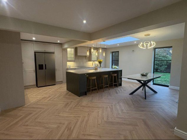Kitchen island with pendant lights and garden doors beyond