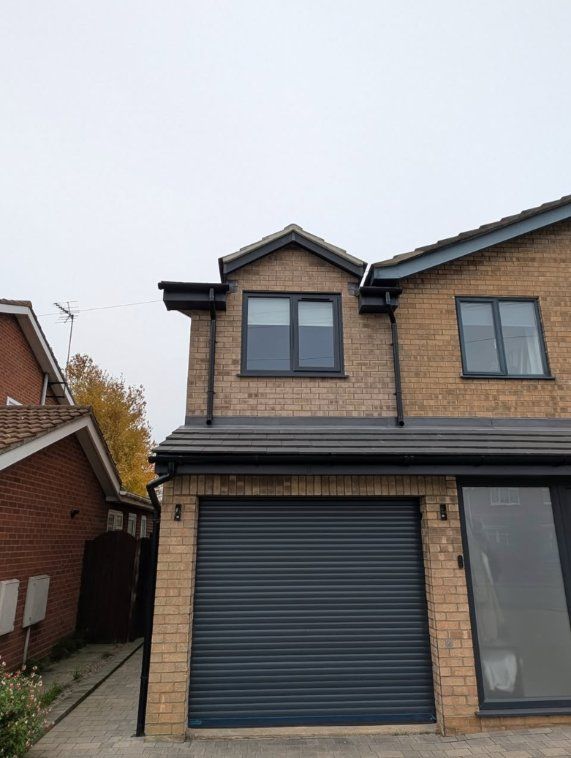 New first-floor room built over a garage in Spalding, buff brick with grey windows