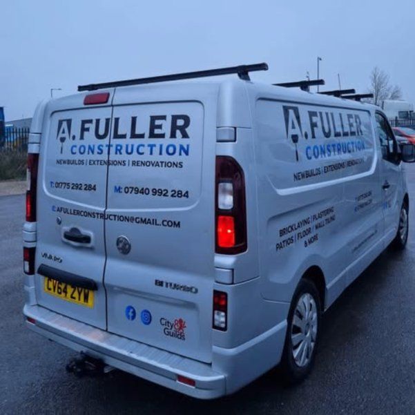 Silver A.Fuller Construction van with the company logo and phone number
